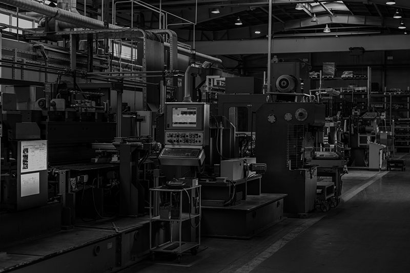 Moderne Industriehalle mit Maschinen und Steuerungssystemen – Branchenbild IT- und OT-Security in der Produktion